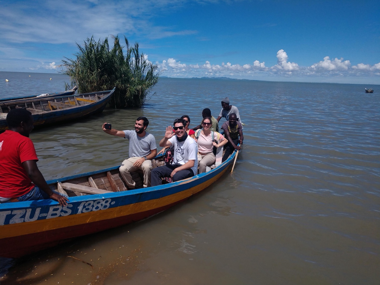 Group of travelers taking a selfie on Lake Victoria wooden boat Tanzania